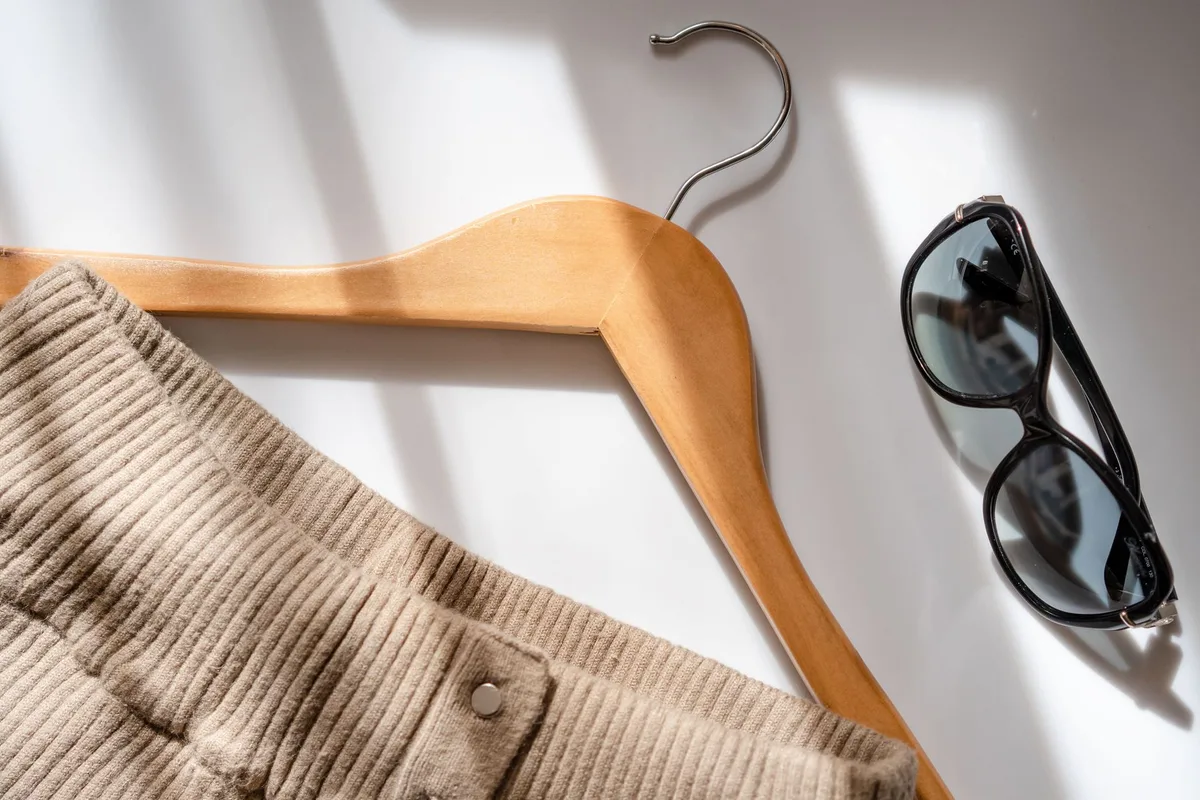 Flat lay clothing photography setup with natural light on white background