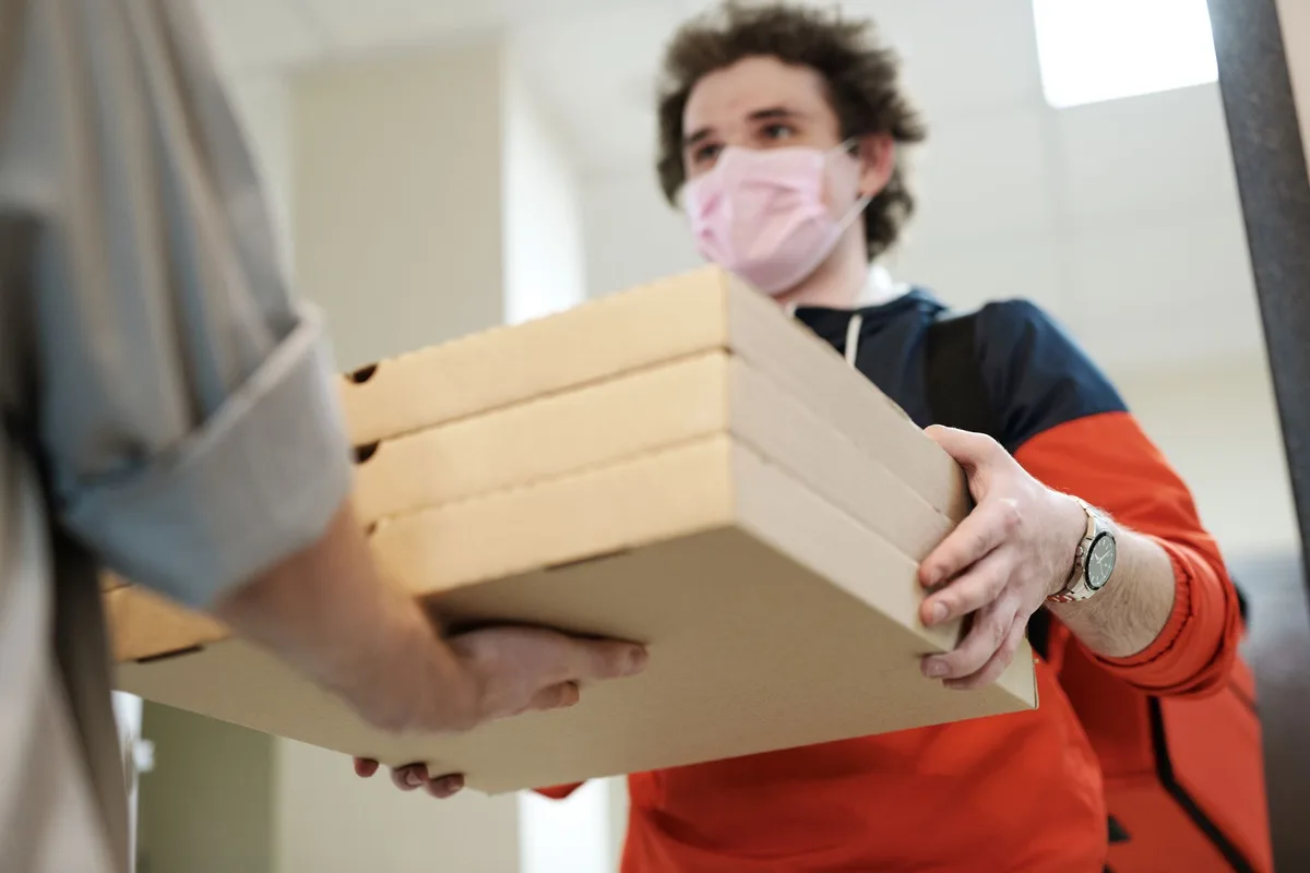 A neatly organized shipping station with boxes, tape, and packaged items ready to be shipped