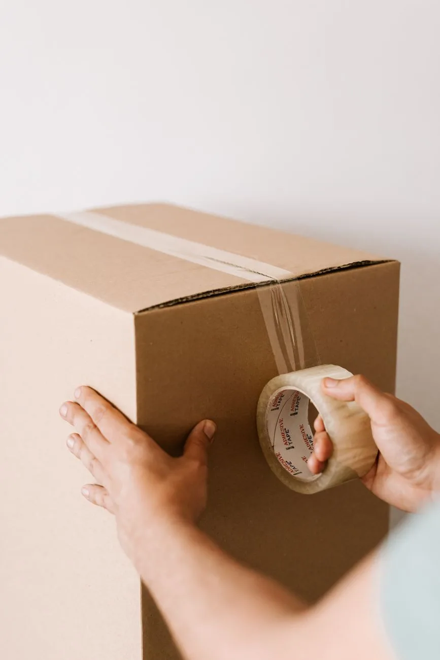 Stacked shipping boxes and packages ready for mailing in a workspace