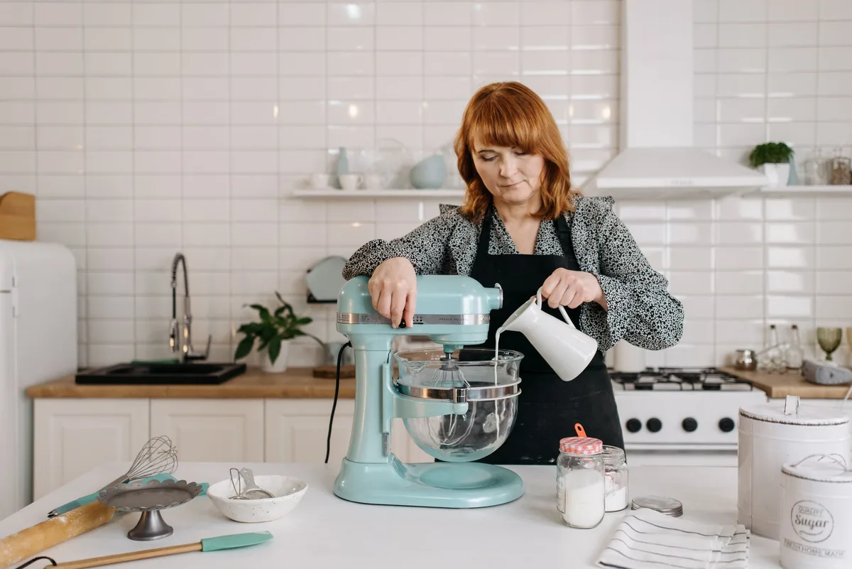 Colorful KitchenAid stand mixers lined up on kitchen counter