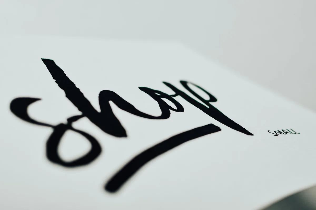 Close-up of a handwritten sign promoting support for small businesses.