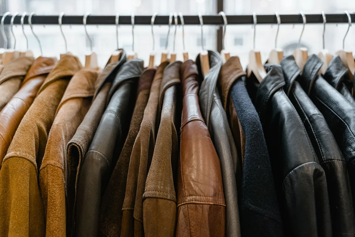 Vintage leather jacket hanging in thrift store ready for purchase